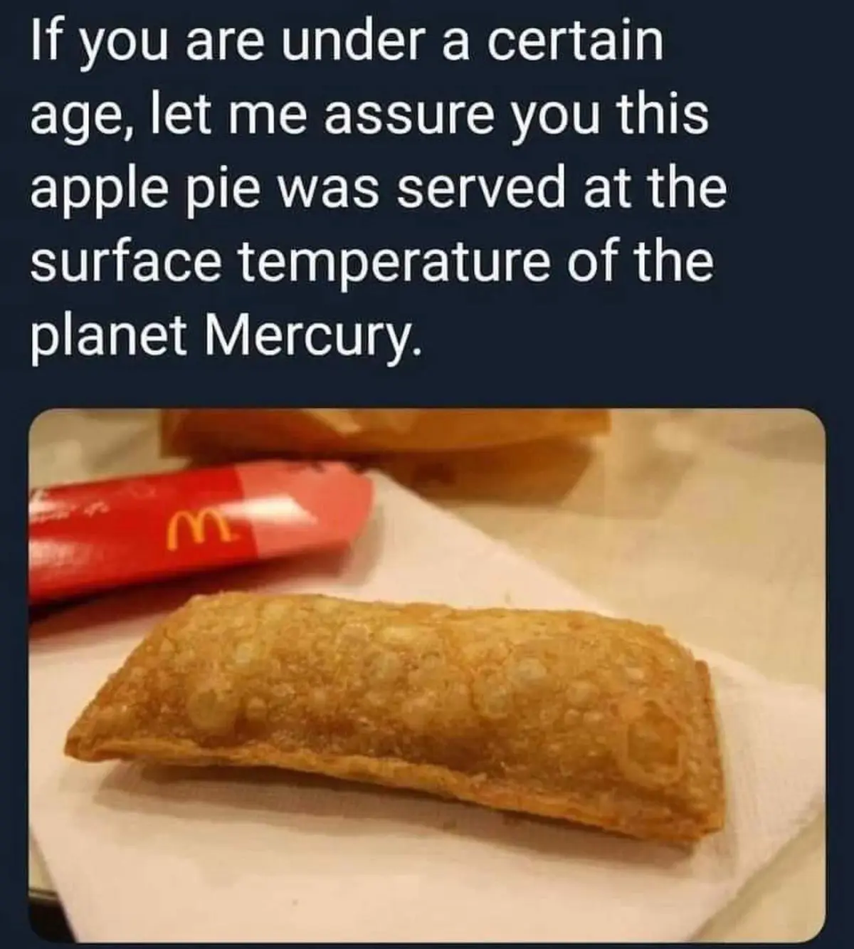 A close-up photo shows a golden-brown, rectangular McDonald's apple pie resting on a white paper napkin, with a red…