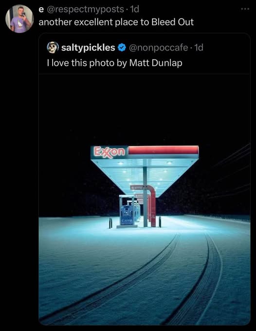A dark, snowy night at an Exxon gas station, illuminated by its bright blue and red canopy lights. Tire tracks lead toward…