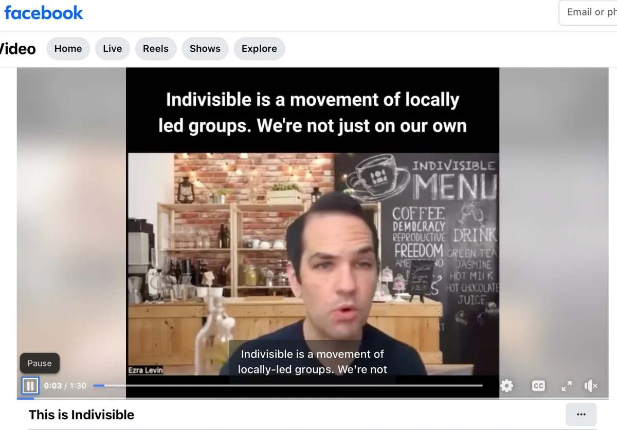 A screenshot of a Facebook video showing Ezra Levin speaking in front of a chalkboard menu labeled 'INDIVISIBLE MENU' with…