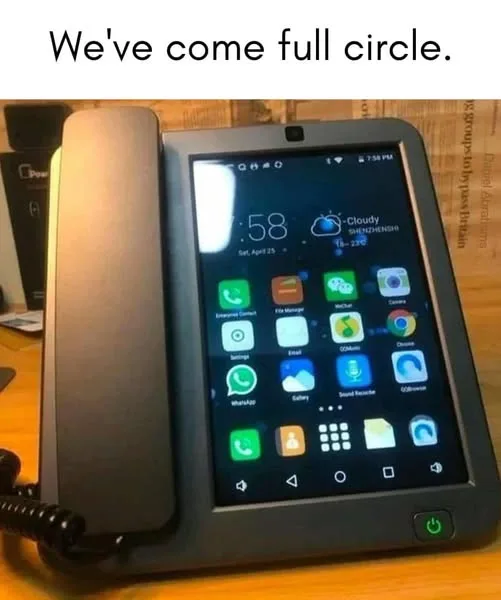A smartphone with a physical telephone handset attached to its top, displaying a typical Android home screen with app icons…