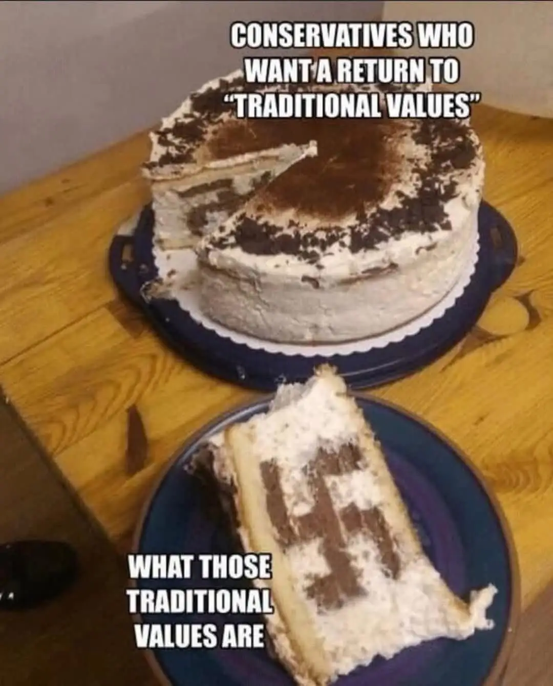 A partially eaten layered cake with chocolate and cream sits on a wooden table. A slice is on a plate in front, showing the…