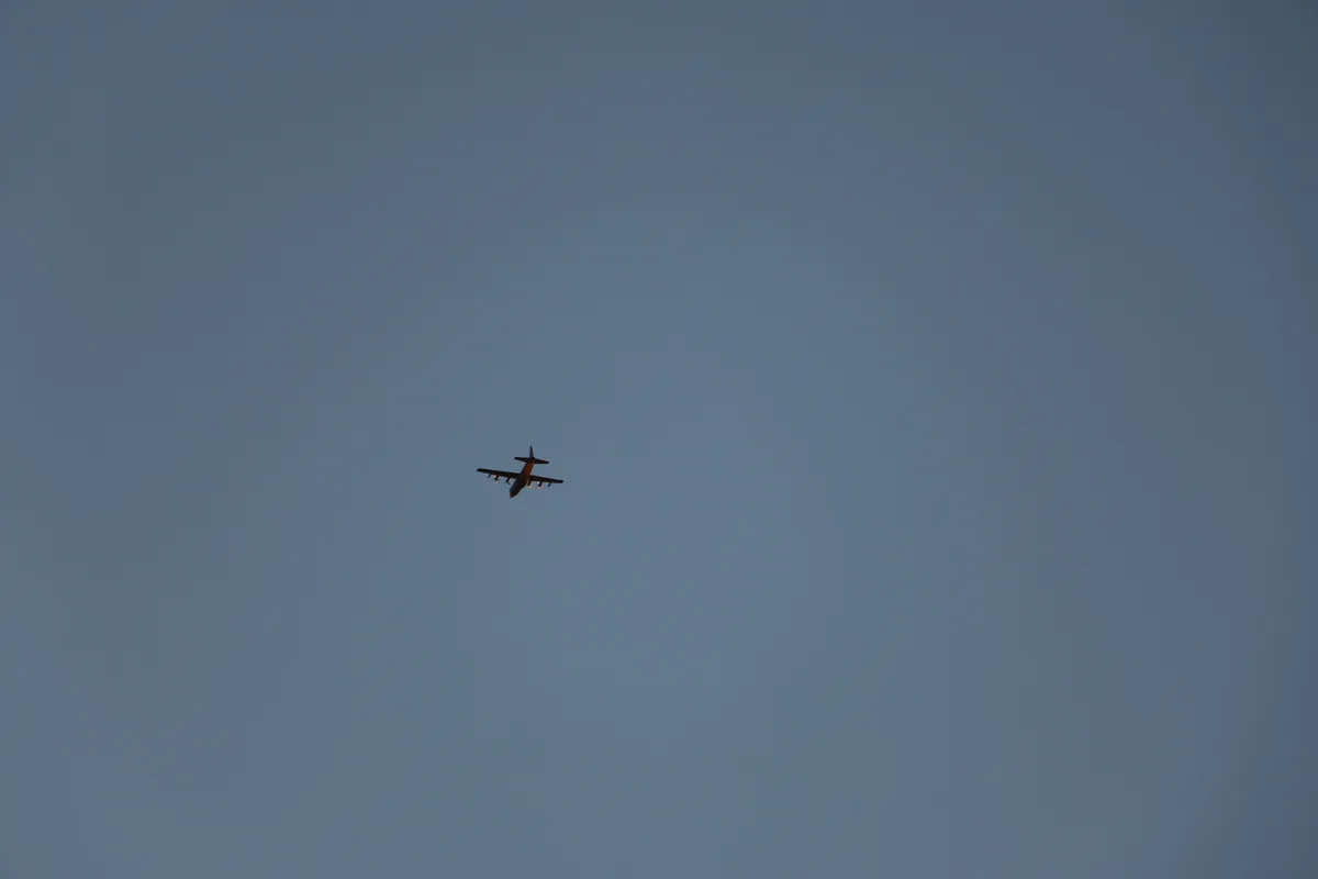 A small airplane is flying alone in a vast, clear blue sky, viewed from below. The overlaid text reads 'i'm not a plane, i'm…