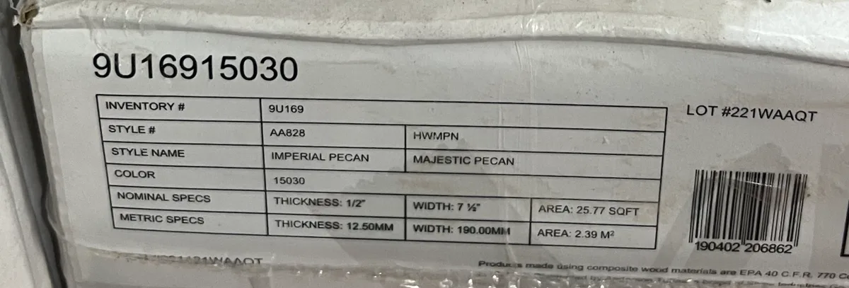 A close-up of a product label on a box showing inventory and style details, including 'STYLE NAME: IMPERIAL PECAN' and…