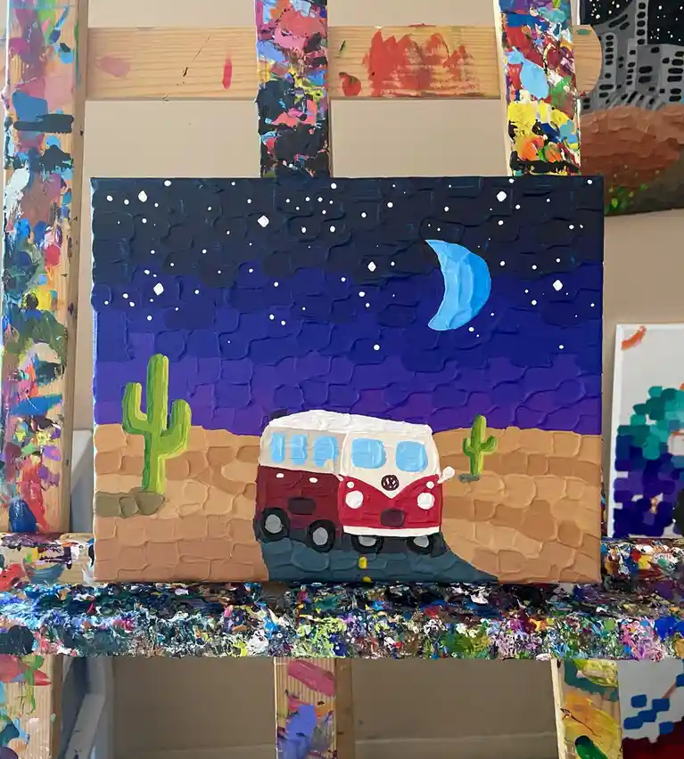 A thickly textured, childlike acrylic painting on canvas depicts a red and white vintage van parked in a desert landscape…