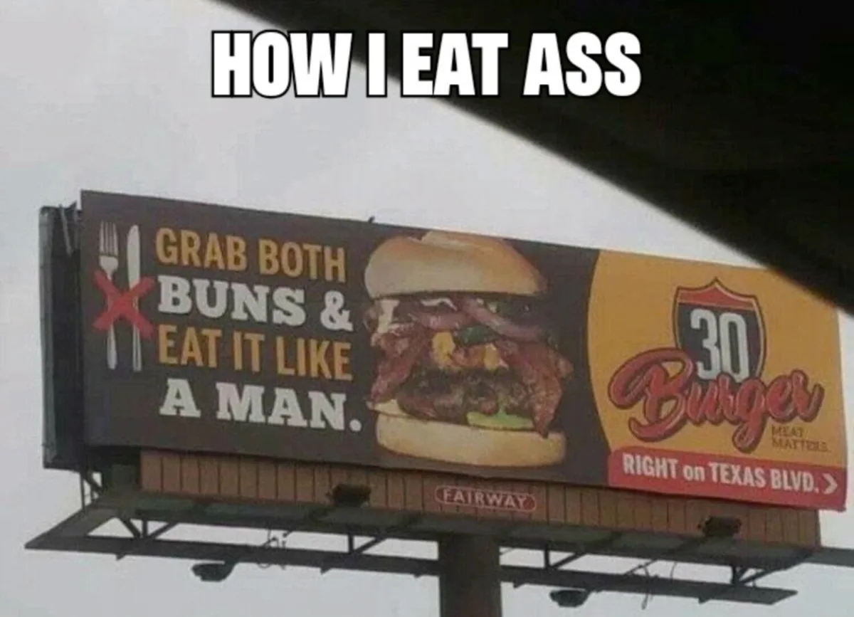 A billboard for 30 Burger advertising 'GRAB BOTH BUNS & EAT IT LIKE A MAN.' with a crossed-out fork and knife, humorously…