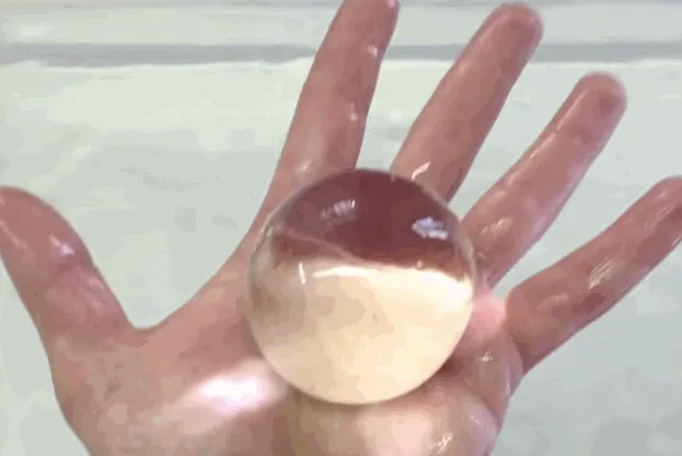 A six-panel sequence shows a hand holding a clear water balloon, submerging it, retrieving it, popping it, holding the…