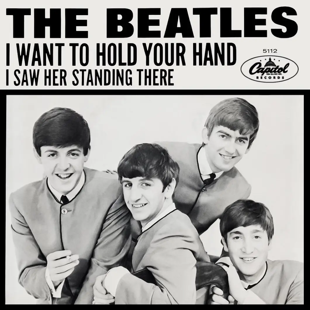 A black-and-white image of The Beatles, four young men in matching suits, posed together with smiles. The album cover text…