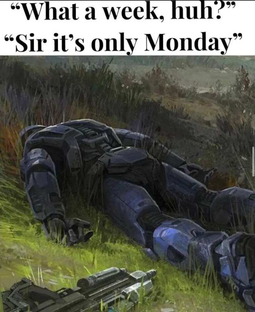 A heavily armored soldier in blue and black combat gear lies defeated on a grassy field, with a weapon nearby. The overlaid…
