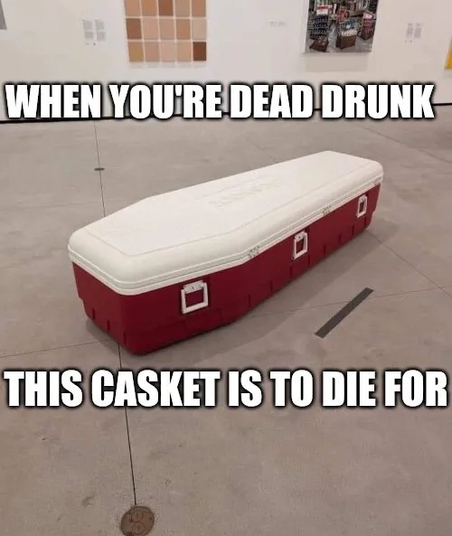 A red and white coffin-shaped cooler sits on a concrete floor in what appears to be a retail or warehouse setting. The…
