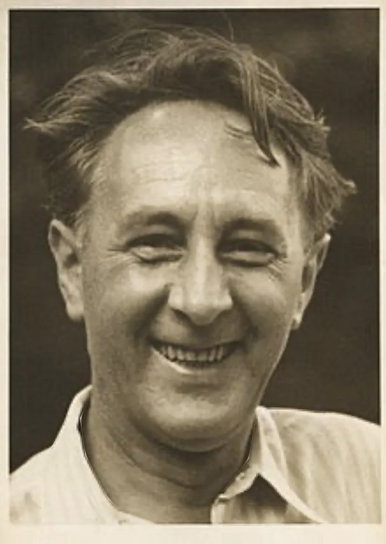 A black-and-white portrait of a smiling middle-aged man with tousled hair, wearing a collared shirt. The overlaid text reads…