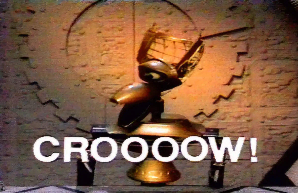 A distorted, glitchy image of a golden, mechanical-looking bird figurine against a textured, puzzle-piece-like background…