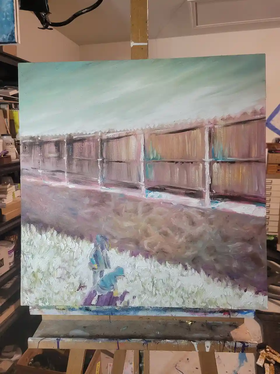 An oil painting on canvas depicts a stylized scene with a fence, a path, and a small figure in blue kneeling in a field of…
