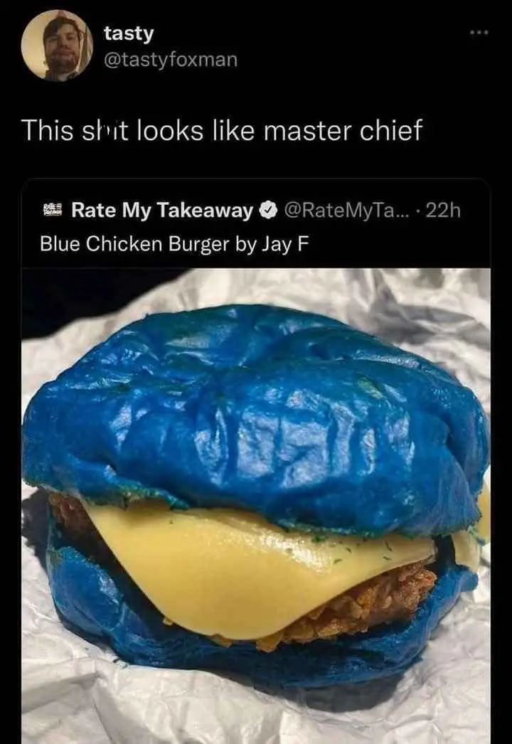 A close-up photo of a burger with a blue-colored bun, cheese, and chicken patty, posted on 'Rate My Takeaway'. The overlaid…