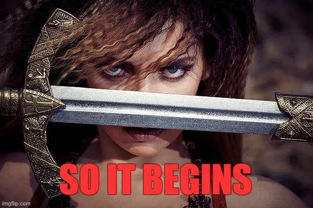 A woman with intense, focused eyes peers over the blade of a large ornate sword held horizontally across her face, obscuring…