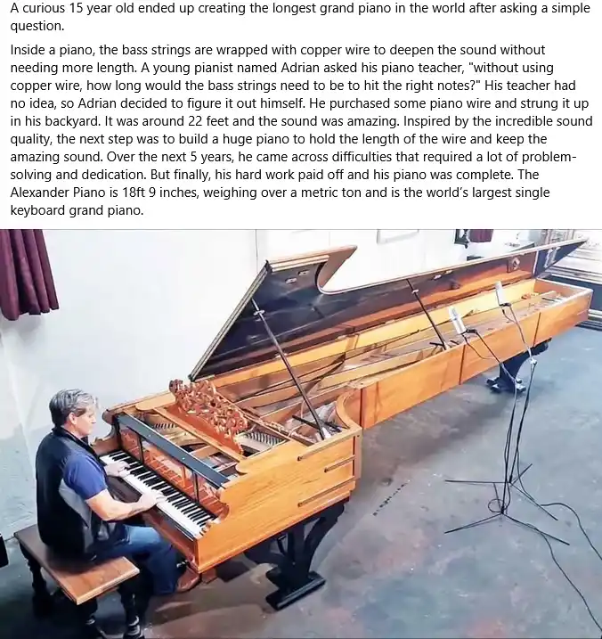a man sits at an extremely long, custom-built grand piano in a workshop, playing it. The piano's lid is open, revealing its…