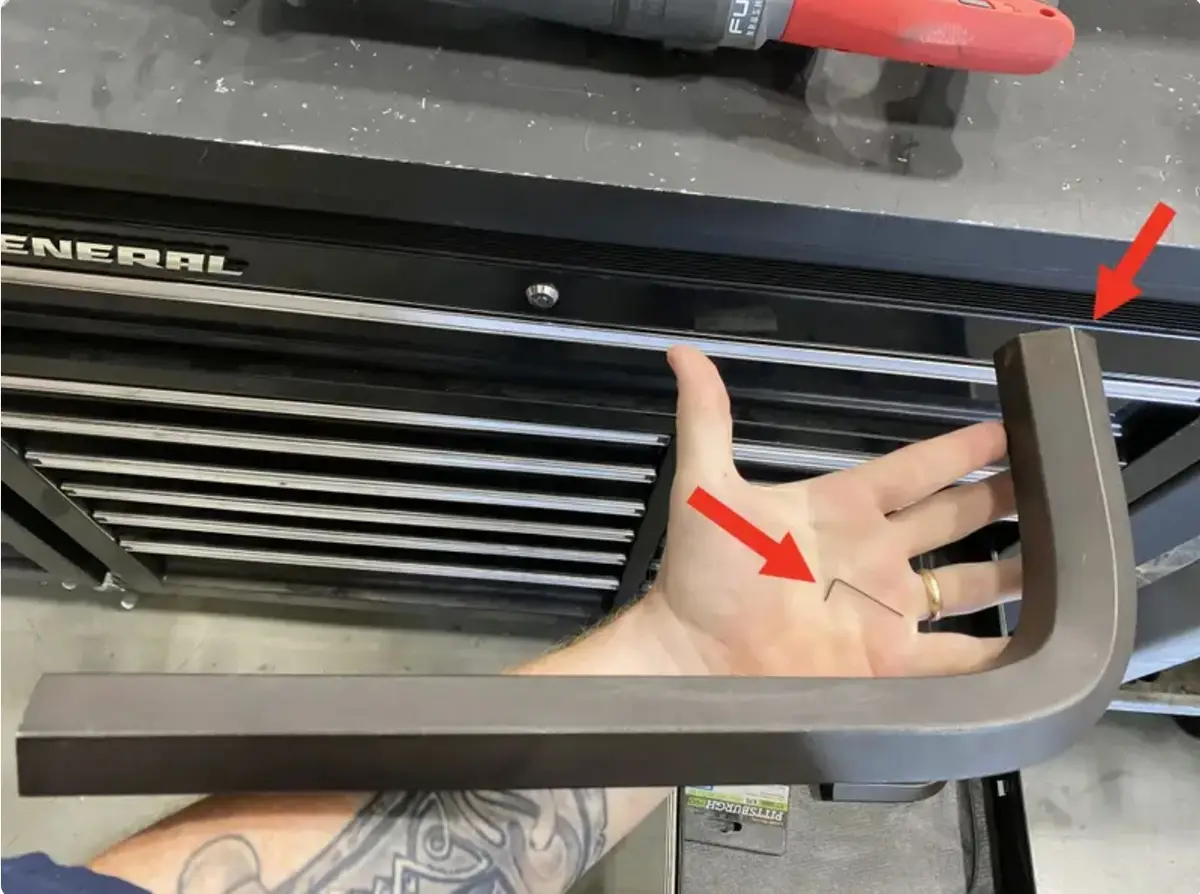 A person's hand is shown with a small metal wire embedded in the palm, indicated by a red arrow. Another red arrow points to…