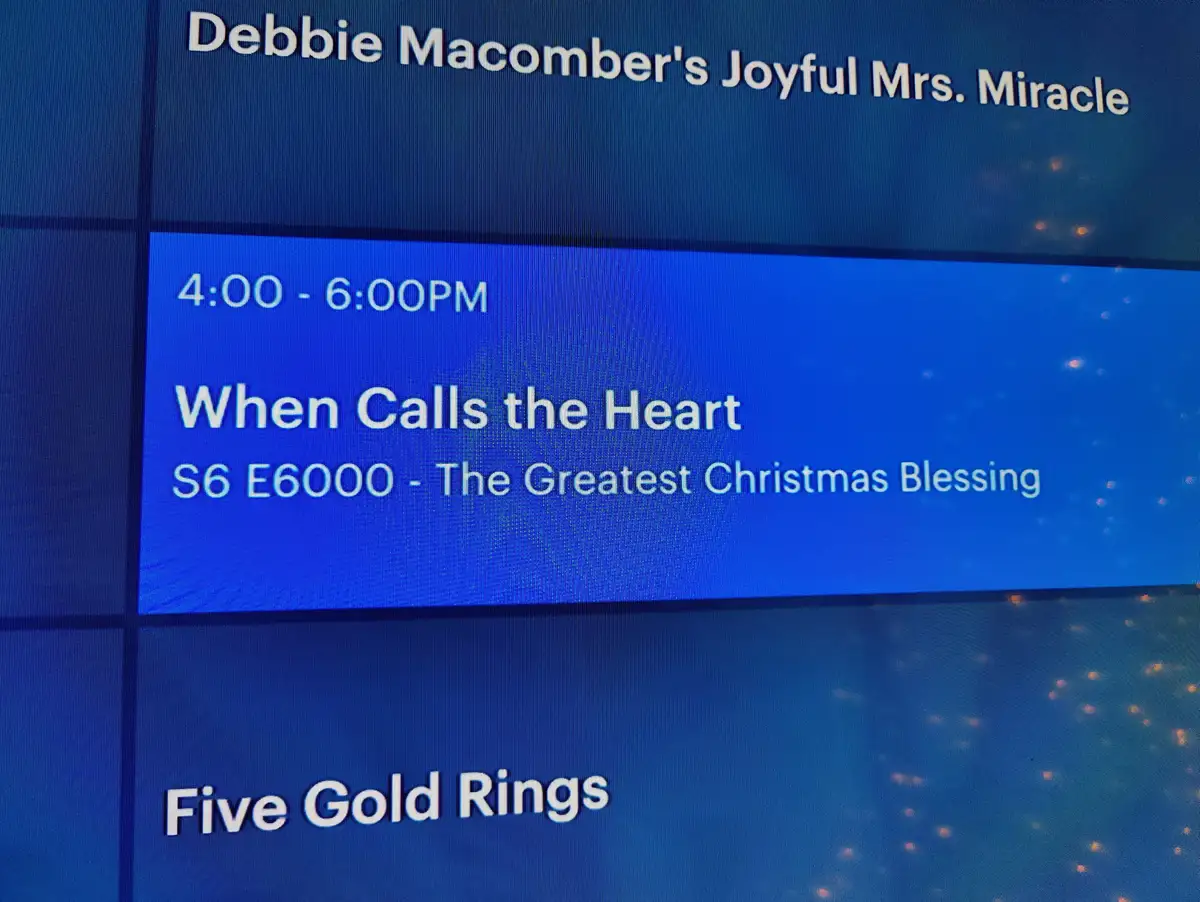 A TV guide screen shows a schedule for 'Debbie Macomber's Joyful Mrs. Miracle' and 'When Calls the Heart' with a fictional…