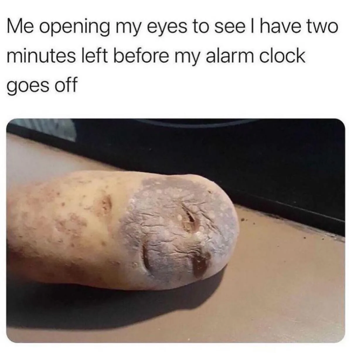 A close-up photo of a potato with two shallow indentations resembling closed eyes, lying on a flat surface. The overlaid…