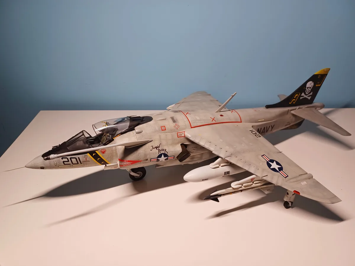 A detailed scale model of a gray U.S. Navy A-7 Corsair II jet fighter, marked with 'NAVY', the number '201', and 'Jumpin'…