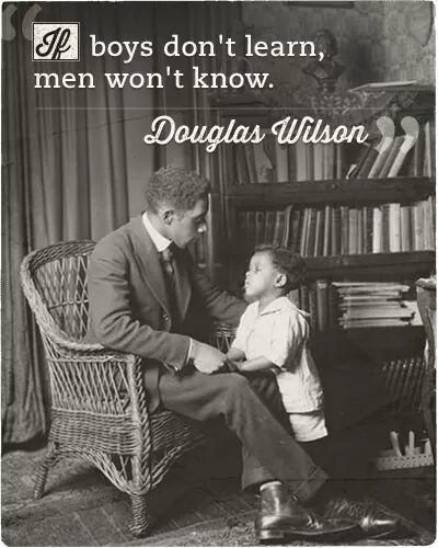 A vintage black-and-white photo shows a man in a suit seated in a wicker chair, gently holding the hand of a young boy who…