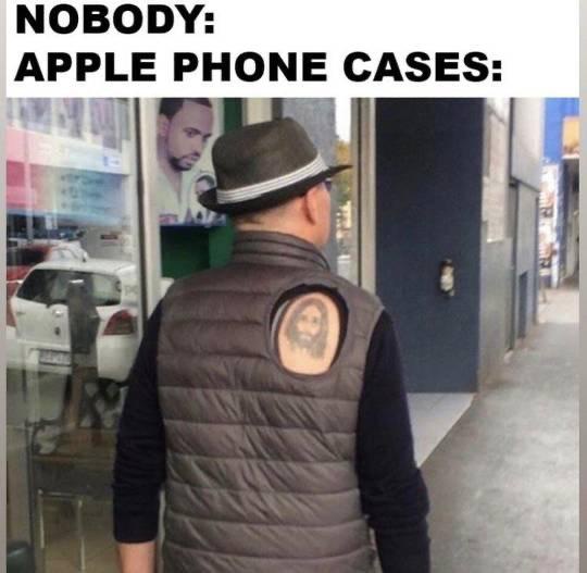 A man viewed from behind wears a brown puffer vest with a large circular cutout on the back, revealing a tattoo of a man's…