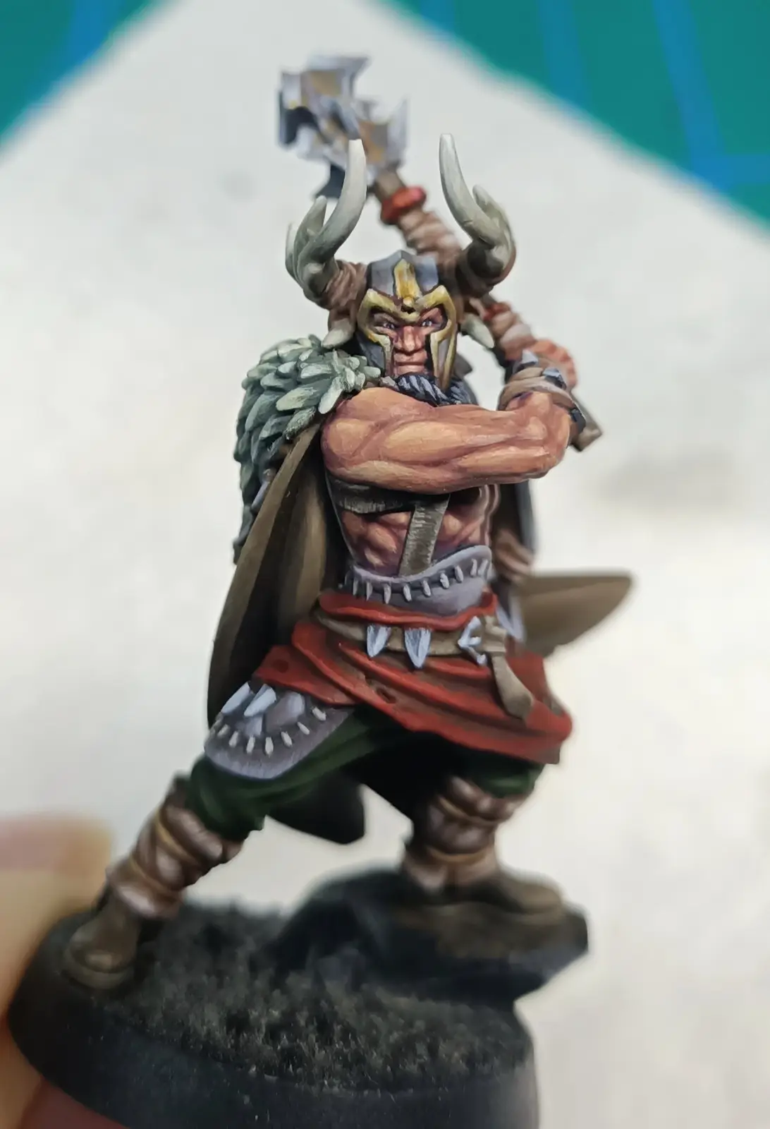 A painted miniature of a muscular, horned warrior with a battle-axe raised, standing on a base, with the text 'i'm not…