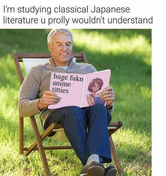 A middle-aged man with gray hair sits in a lawn chair outdoors, smiling while reading a pink book. The book's left page…