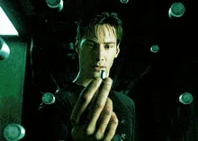 A six-panel image sequence from 'The Matrix' showing Neo holding a pill, then dropping it, and finally watching it fall to…