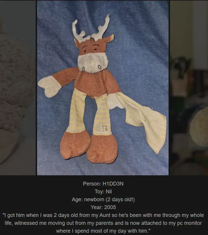 A worn, brown plush moose toy with white antlers and striped yellow-and-white pants lies on a blue fabric surface. Overlaid…