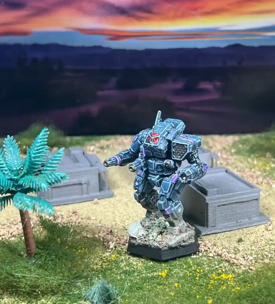 A painted miniature of a blue and purple armored robot stands in a diorama with fake grass, a small palm tree, and two gray…