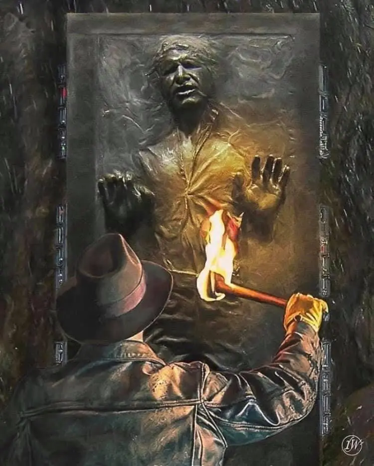 A person in a fedora and leather jacket holds a flaming torch to the chest of a frozen Han Solo statue embedded in…