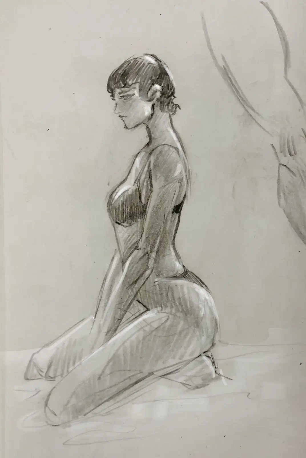 A pencil sketch of a woman kneeling in profile, wearing a bra and panties, with unfinished sketch lines visible in the…