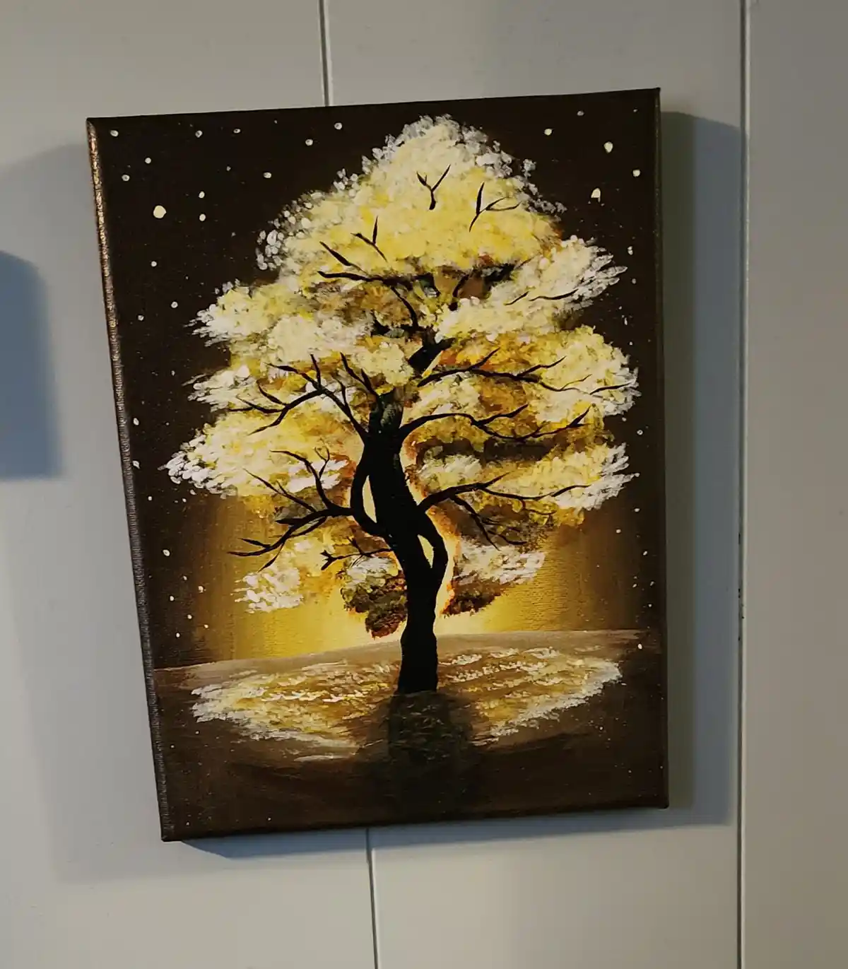 A painting of a stylized tree with a dark trunk and branches, set against a dark background with white speckles resembling…
