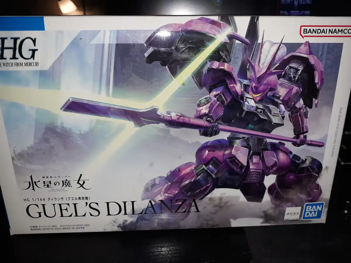 A close-up photo of a Bandai Namco model kit box for 'Guel's Dilanza' from the anime 'The Witch From Mercury'. The box art…