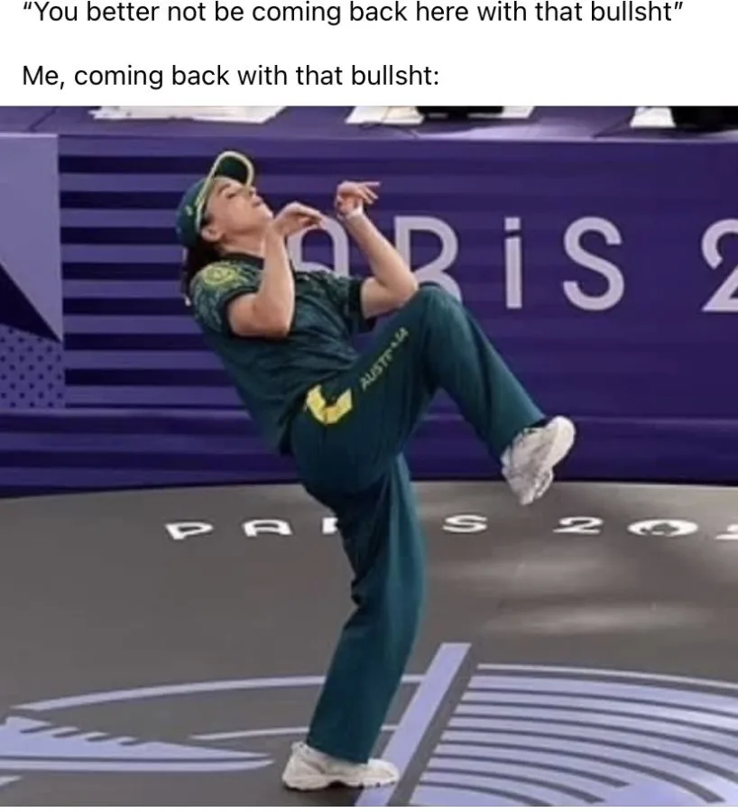 A female athlete in an Australian green uniform and cap is captured mid-motion, kicking one leg high while balancing on one…