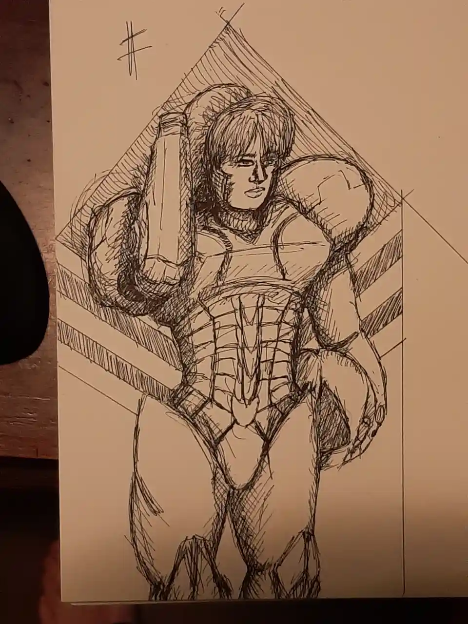 A hand-drawn sketch on paper depicts a muscular, shirtless male figure with short hair, wearing a detailed armored vest and…
