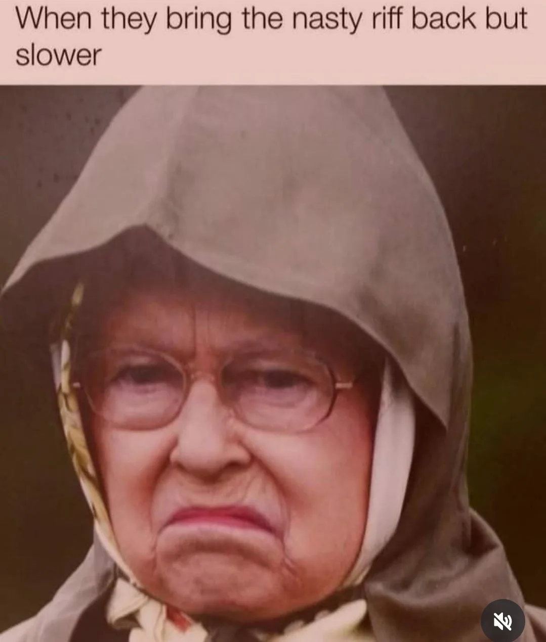The image shows a close-up of an elderly woman wearing glasses and a hooded garment, with a deeply scrunched, annoyed, and…