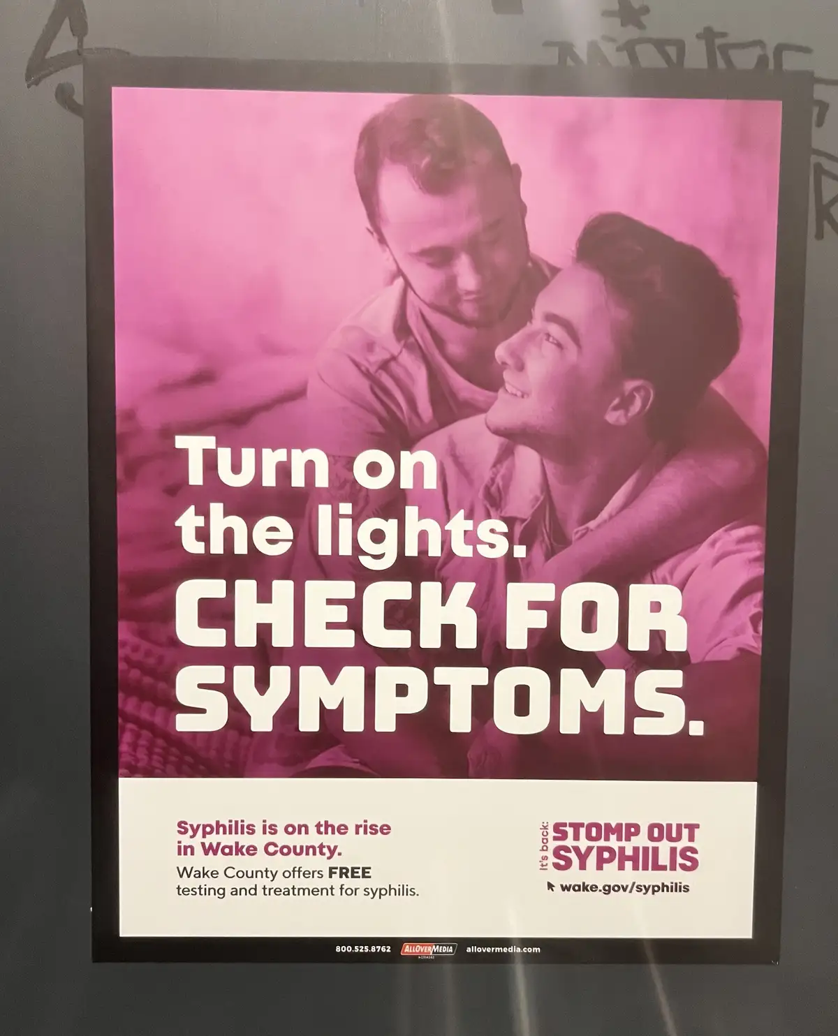 A public health poster with a pink-tinted photo of two men in an intimate pose, overlaid with bold white text reading 'Turn…