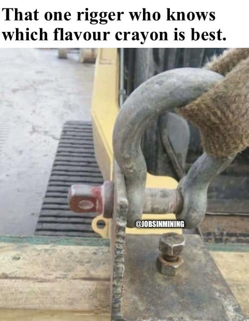 A close-up photo shows a gloved hand holding a large, rusty metal shackle attached to heavy machinery. The shackle is…