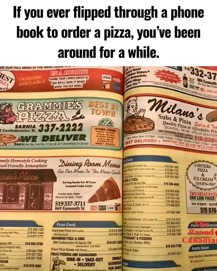 The image shows an open phone book filled with pizza restaurant advertisements, featuring names like 'Grammie's Pizza &…