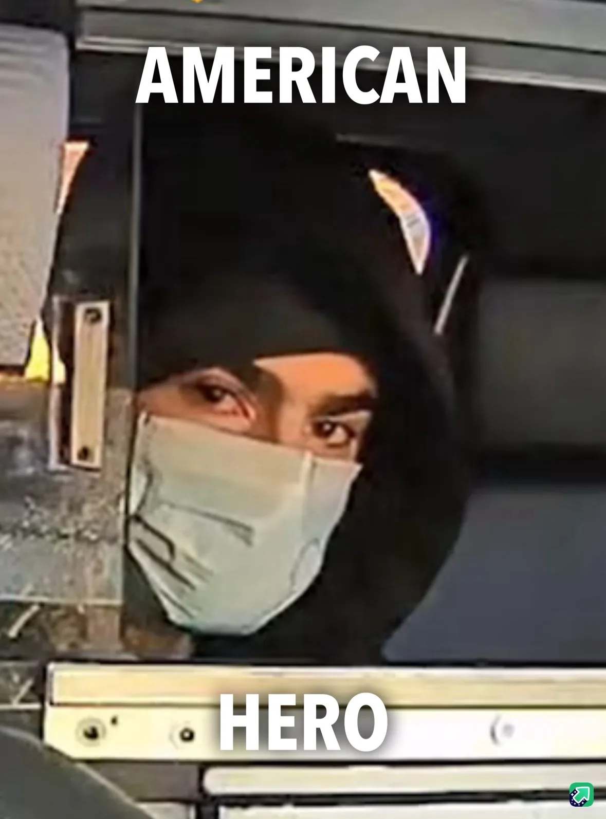 A grainy security camera image shows a person wearing a black head covering and a light-colored face mask, looking out from…