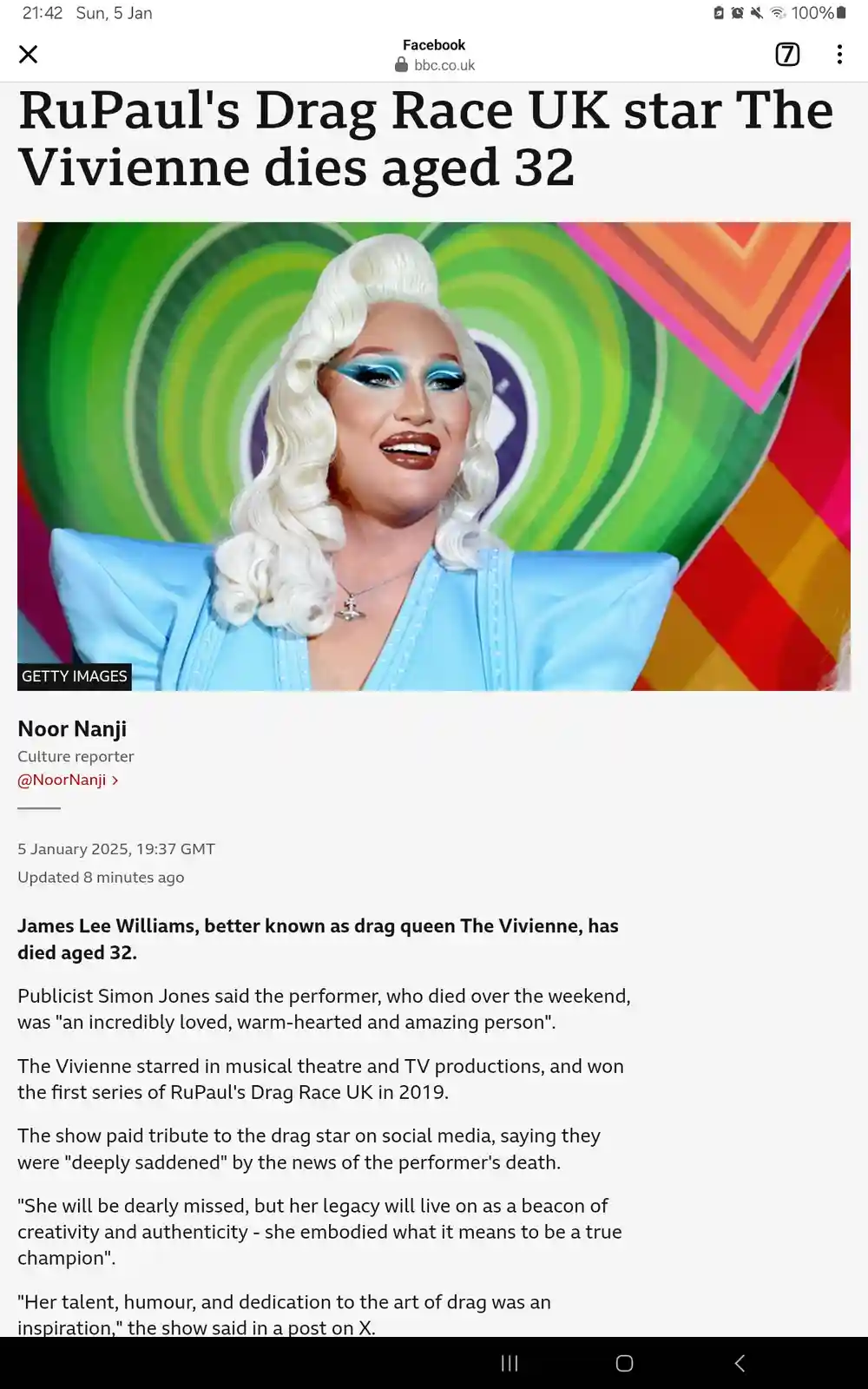 A screenshot of a BBC news article on Facebook about the death of drag queen The Vivienne, showing her smiling photo in a…