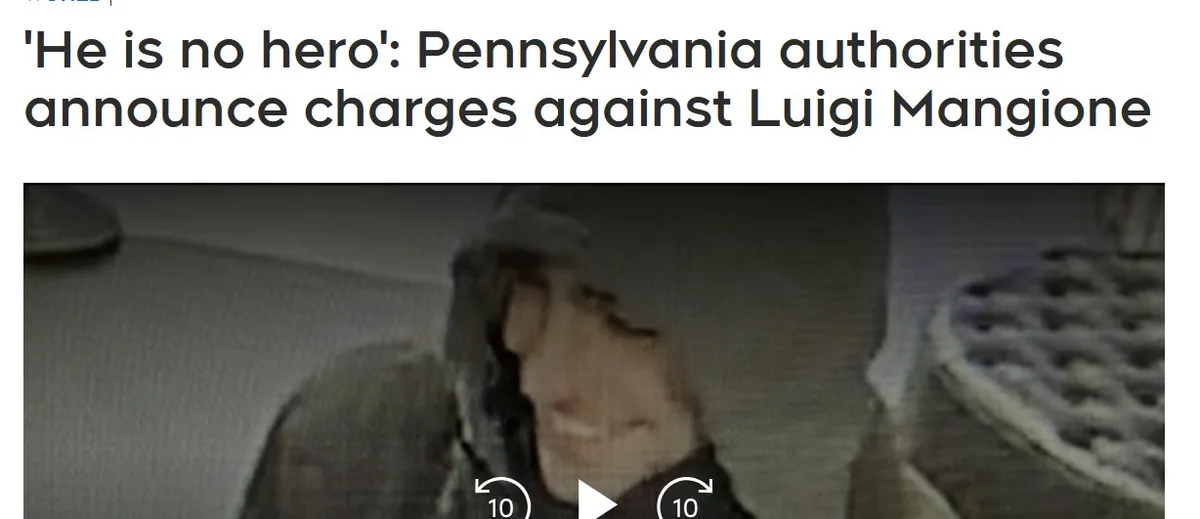 A grainy, low-resolution security camera image shows a person wearing a dark hoodie, smiling faintly while holding a pizza…