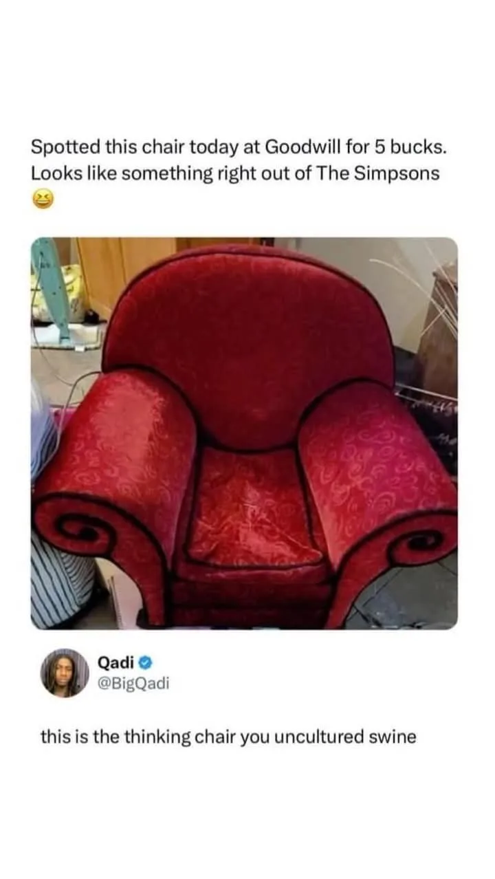 A red, ornate armchair with swirling armrests and a high back is shown in a cluttered room. Overlaid text reads 'Spotted…