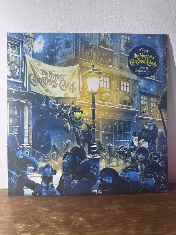 A vinyl record cover for Disney's 'The Muppet Christmas Carol' featuring Kermit the Frog and a smaller Muppet character…