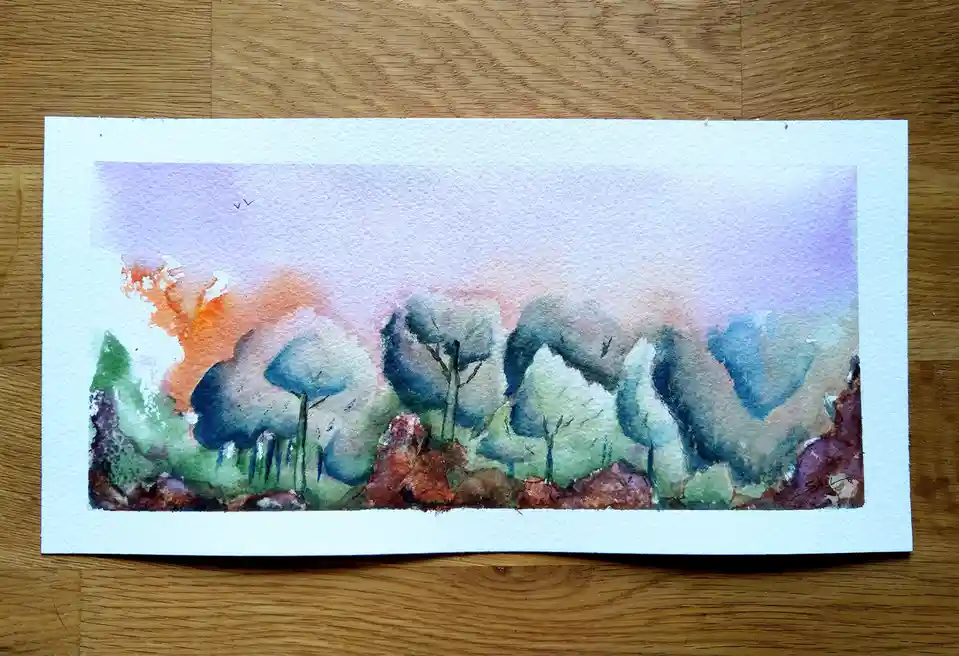 A watercolor painting of stylized trees with blue and green foliage under a purple and orange sky, resting on a wooden…