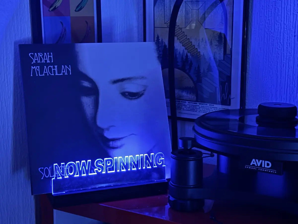 A vinyl record player with an 'AVID SEQUEL TURNTABLE' is shown next to a Sarah McLachlan album cover for 'Solace'. The album…