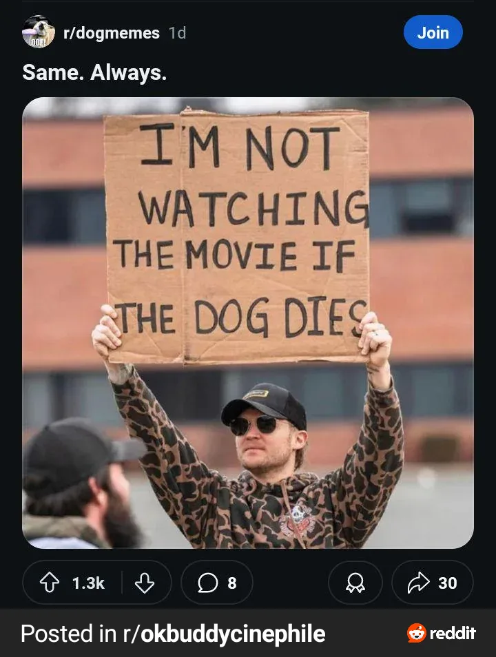 A man in a leopard-print hoodie and sunglasses holds up a cardboard sign that reads 'I'M NOT WATCHING THE MOVIE IF THE DOG…