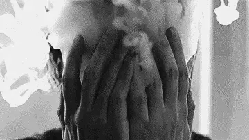 A black-and-white image sequence shows a person with hands covering their face, surrounded by swirling smoke or vapor…